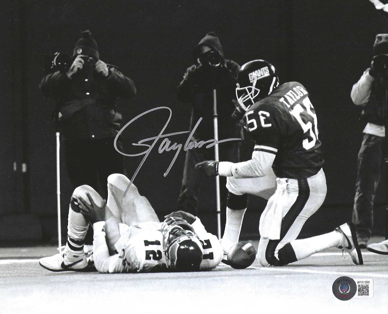 This photograph has been personally hand-signed by Lawrence Taylor.  It comes with an individually numbered, tamper proof certificate of authenticity from Becketts. This ensures authenticity, and can be reviewed online. This shows that the product purchased is authentic and eliminates any possibility of duplication or fraud.